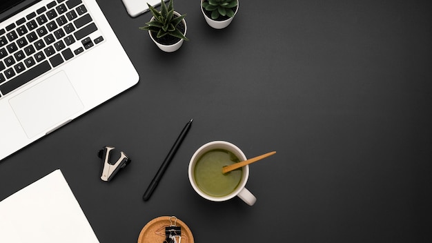 Flat lay of workstation with cup of tea and copy space