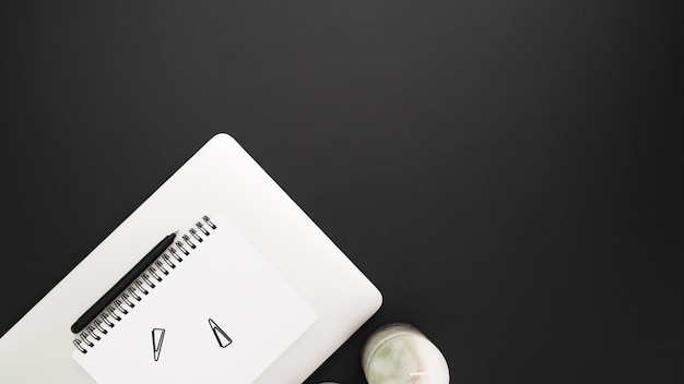 Flat lay of workstation with notebook and copy space