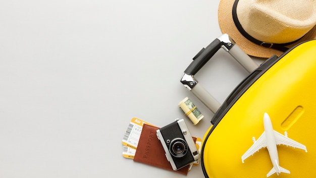 Free photo flat lay yellow luggage with copy-space