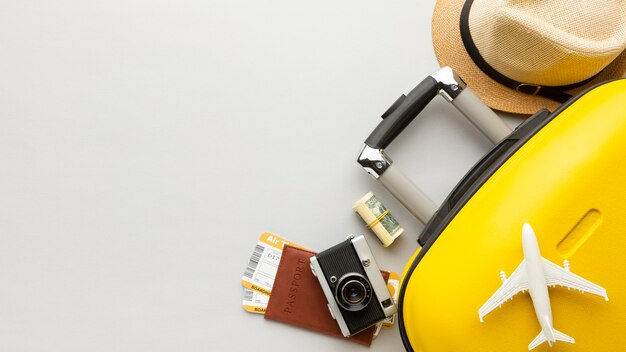 Flat lay yellow luggage with copy-space