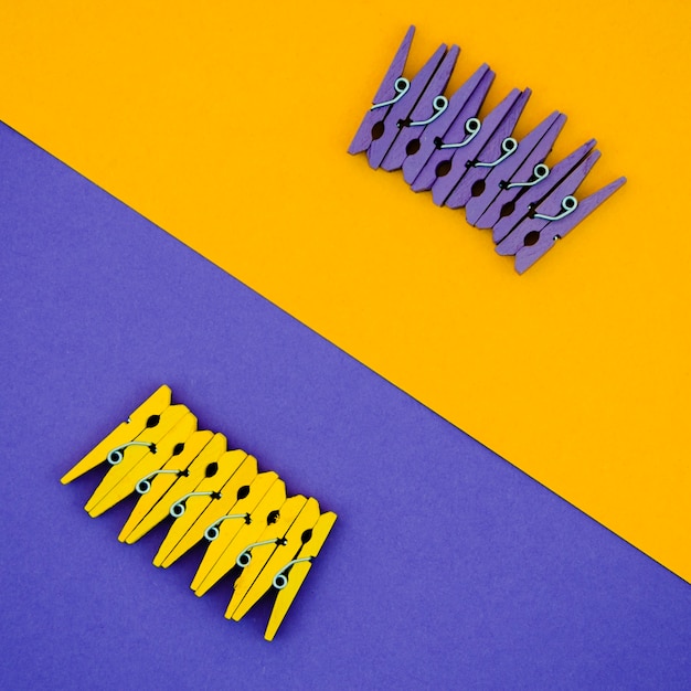 Flat-lay yellow and purple clothes pins 