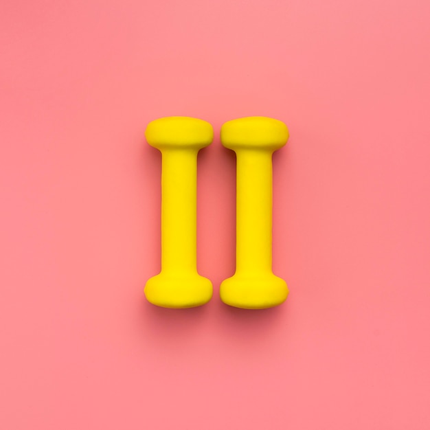 Free photo flat lay of yellow weights