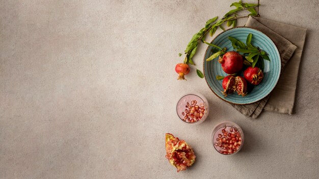 Flat lay of yogurt with pomegranate and copy space