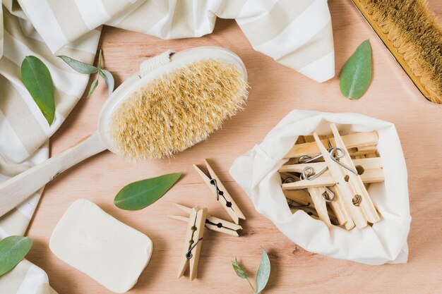 Flat lay zero waste assortment on wooden background with clothespins