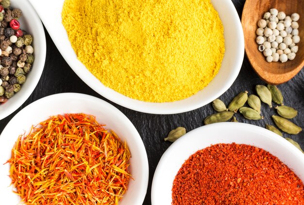 Flavored bowls with spices on table