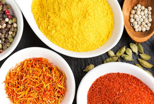 Flavored bowls with spices on table