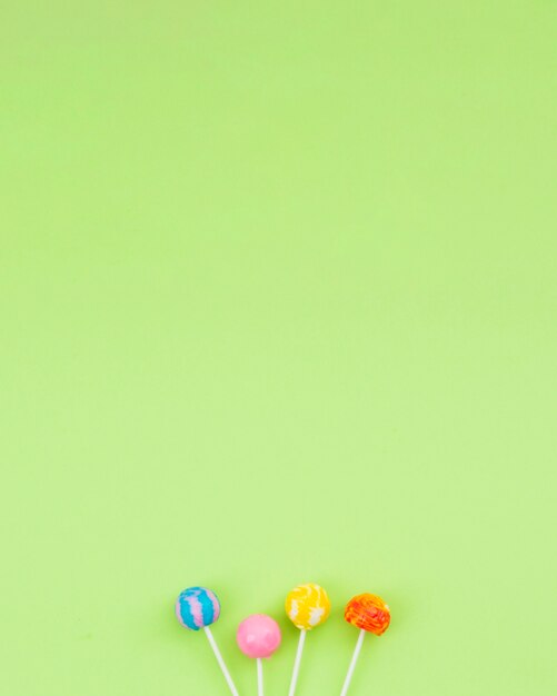 Flavored lollipops on table with copy-space