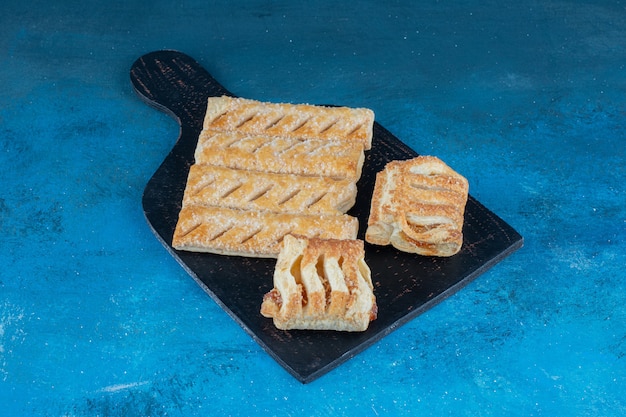 Flavorful cookies on the wooden board ,on the blue background . High quality photo