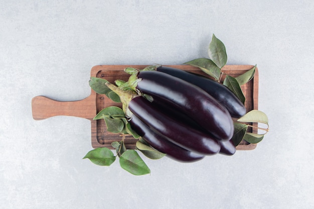 Flavorful eggplant on the board, on the marble surface