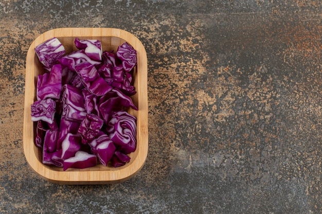 Flavorful red cabbage in the bowl , on the marble surface