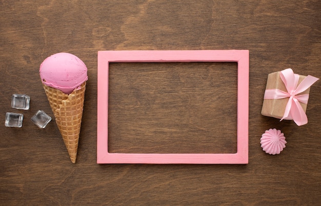 Free photo flavoured ice cream on cone with frame and gift