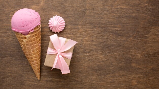 Flavoured ice cream on cone with gift