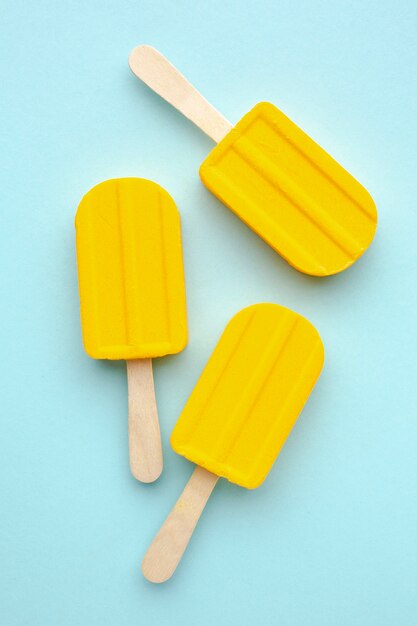 Flavoured ice cream on stick on table