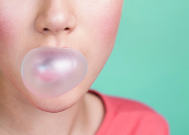 Free photo flawless person blowing bubble gum