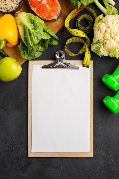 Flay lay of clipboard mock-up with groceries