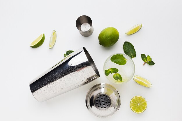 Flay lay of cocktail essentials with lime and mint