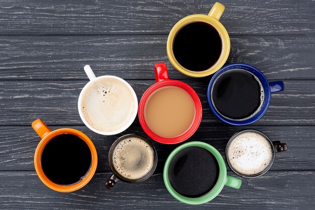 Flay lay of coffee cups on wooden table