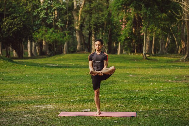 Flexible man posing in the park