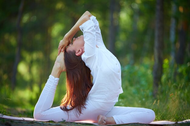 Flexible woman doing yoga exercises