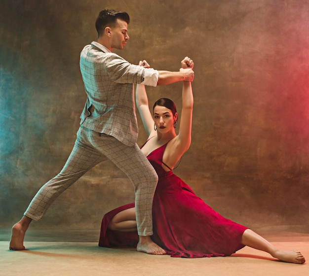 Flexible young modern dance couple posing in.