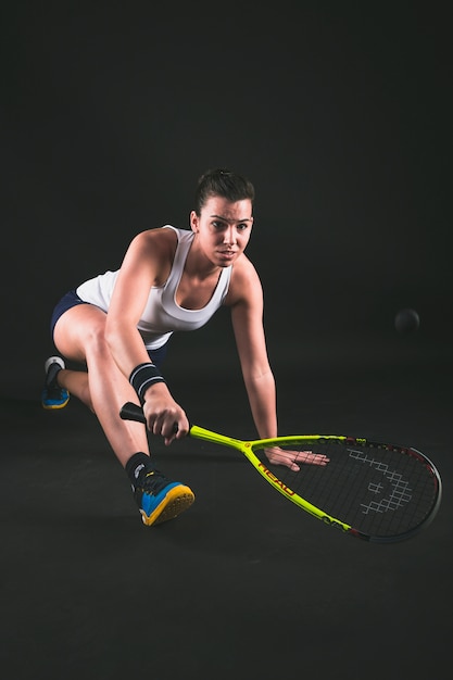 Flexible young player hitting the ball