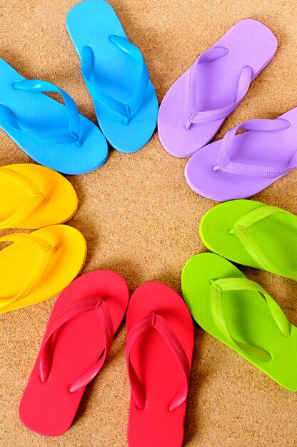 Flip flops collection over the sand