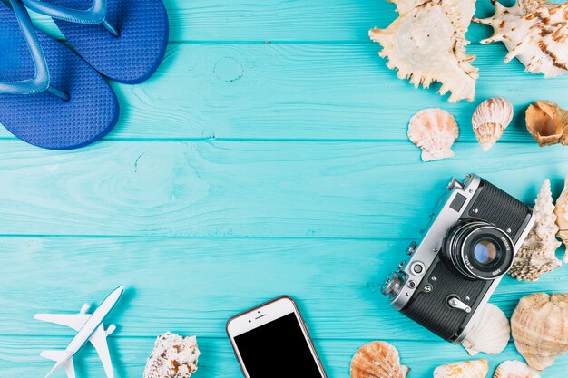 Flip-flops near camera and seashells