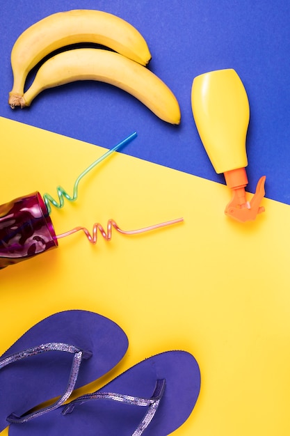 Flip flops near spray and fruits with glass