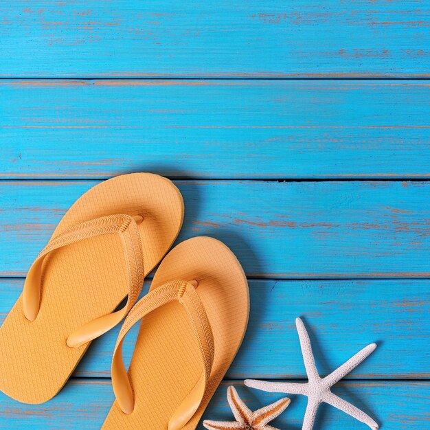 Flip flops starfish old bright blue beach wood square