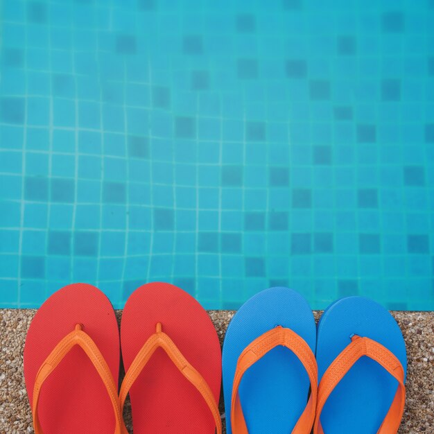 Flip flops next to the swimming pool