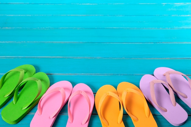 Flip flops on wooden blue background