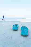 Free photo flipflops on a sandy ocean beach