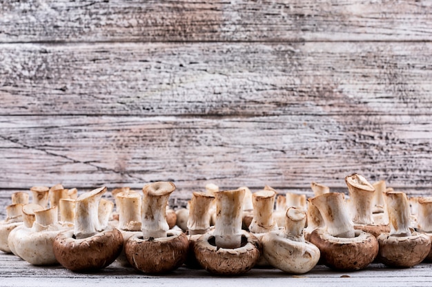 Flipped mushrooms on a wooden table. side view.