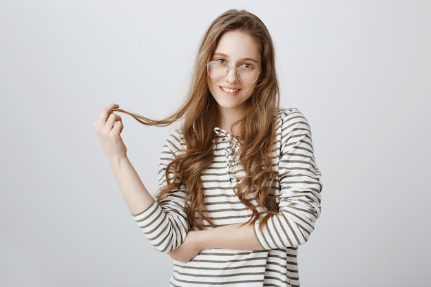 Free photo flirty girl in glasses, playing with hair coquettish