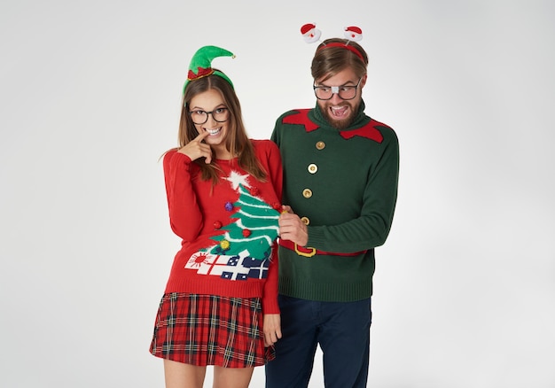 Free photo flirty nerds in christmas jumpers