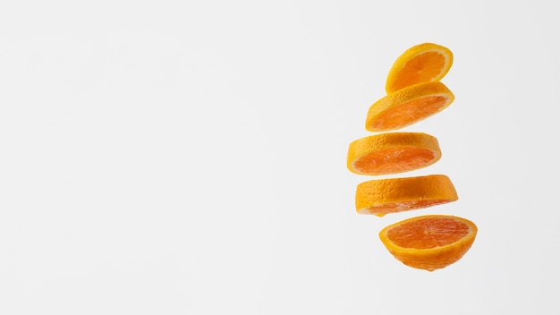 Free photo floating slices orange with clear background