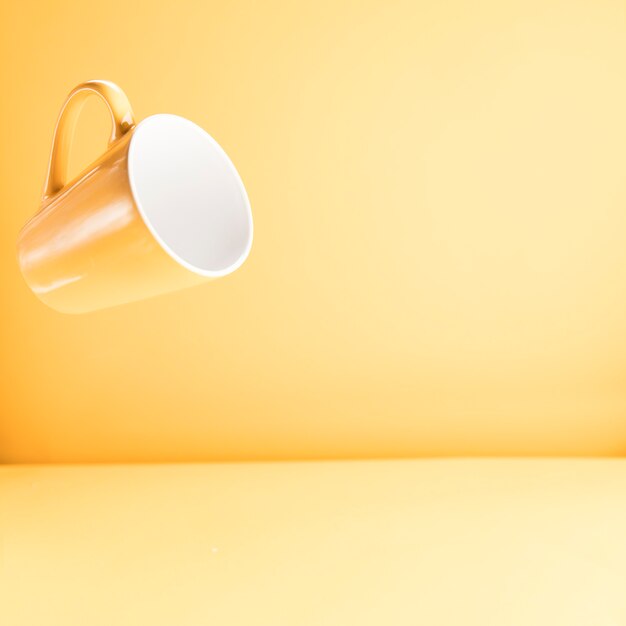 Floating yellow mug with copyspace