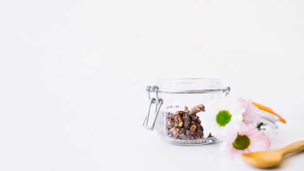 Floral decoration with nuts in glass and space on left