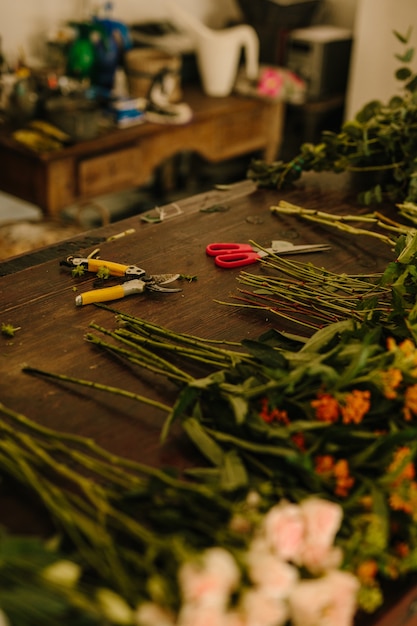 Floral design studio with scissors and flowers on the table