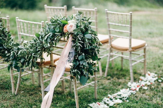 Floral garlands of green eucalyptus and pink flowers decorate we