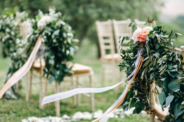 Floral garlands of green eucalyptus and pink flowers decorate we