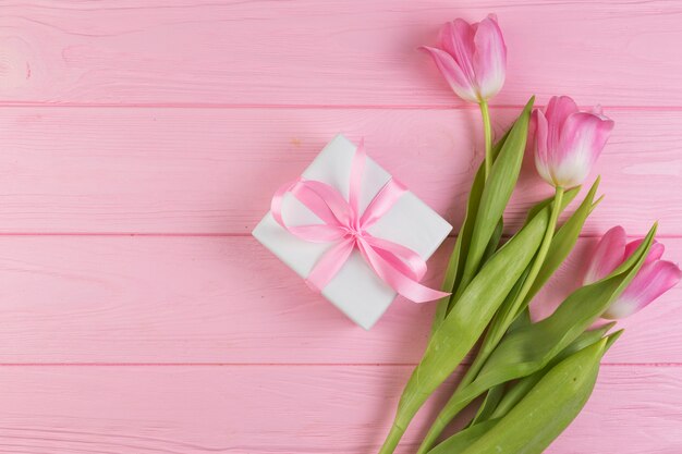 Floral mothers day composition with roses and present box