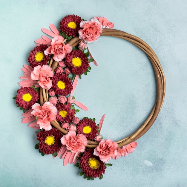 Floral wreath with carnations and daisies with copy space