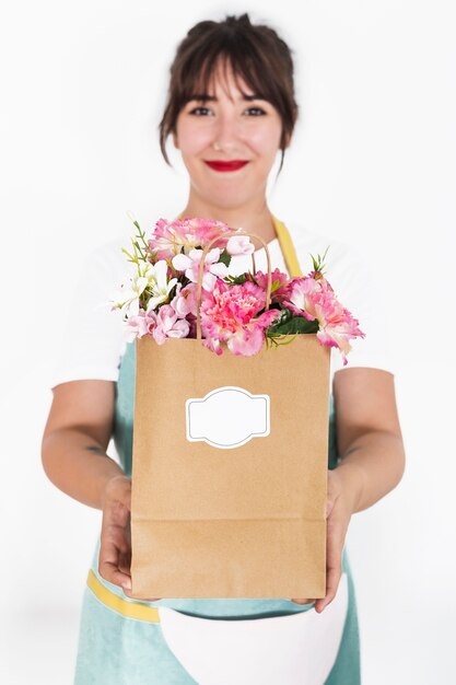 Florist hand holding flower paper bag on white background