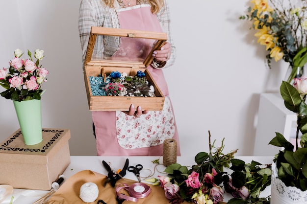 Florist holding box with decorations