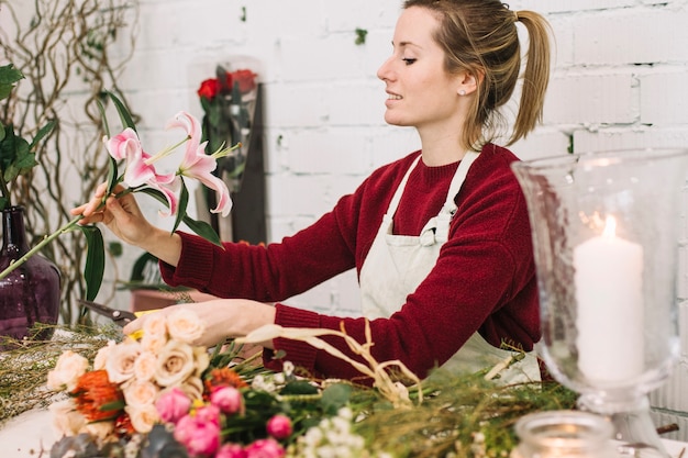 Florist looking at lily for bouquet