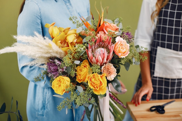 Florist makes a beautiful bouquet in a studio