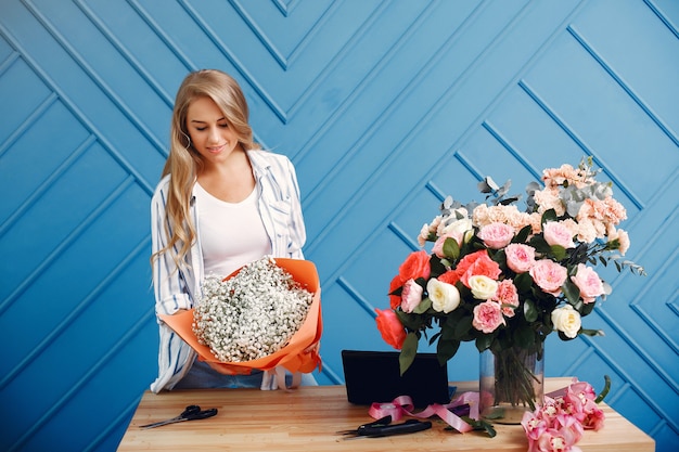 Florist makes a beautiful bouquet in a studio