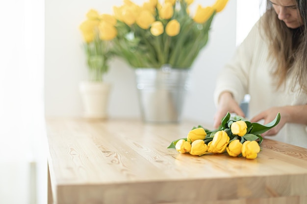 Florist makes a beautiful bouquet tulips