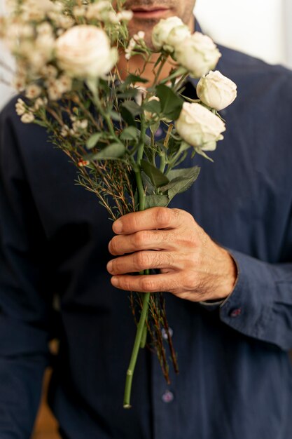 Florist male holding a beautiful bouquet of flowers